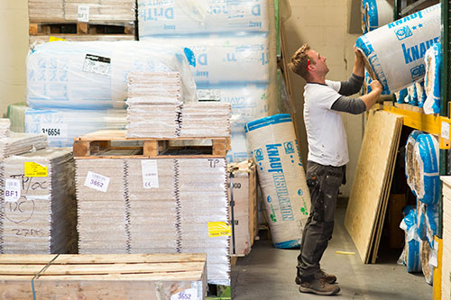 installer lifting materials in warehouse